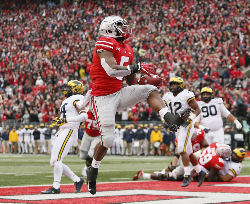 First Place, Team Picture Story - Adam Cairns / The Columbus Dispatch, "Ohio State vs. Michigan"Ohio State running back Mike Weber Jr. (5) celebrates a 2-yard touchdown run during the third quarter against Michigan at Ohio Stadium in Columbus on Nov. 24, 2018. 