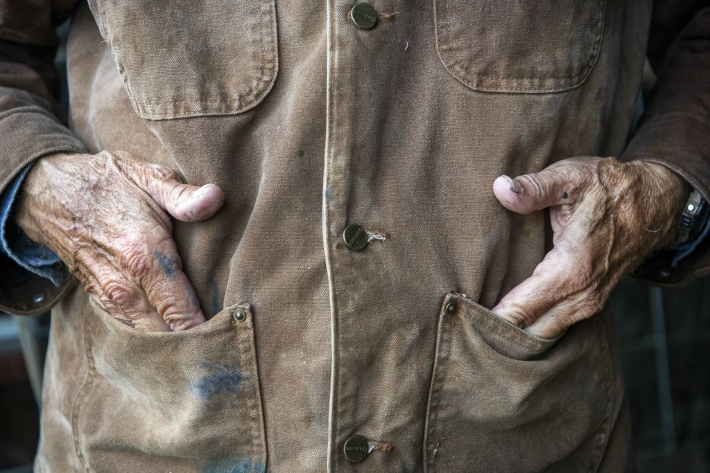 First Place, Chuck Scott Student Photographer of the Year - Gaelen Morse / Ohio UniversityLowell puts his hands into his coverall pockets as he watches rain blanket his farm in Cynthiana, Ky., on the morning of Oct. 30, 2019. After decades of farming, Lowell says it gets harder and harder to keep up with the work.