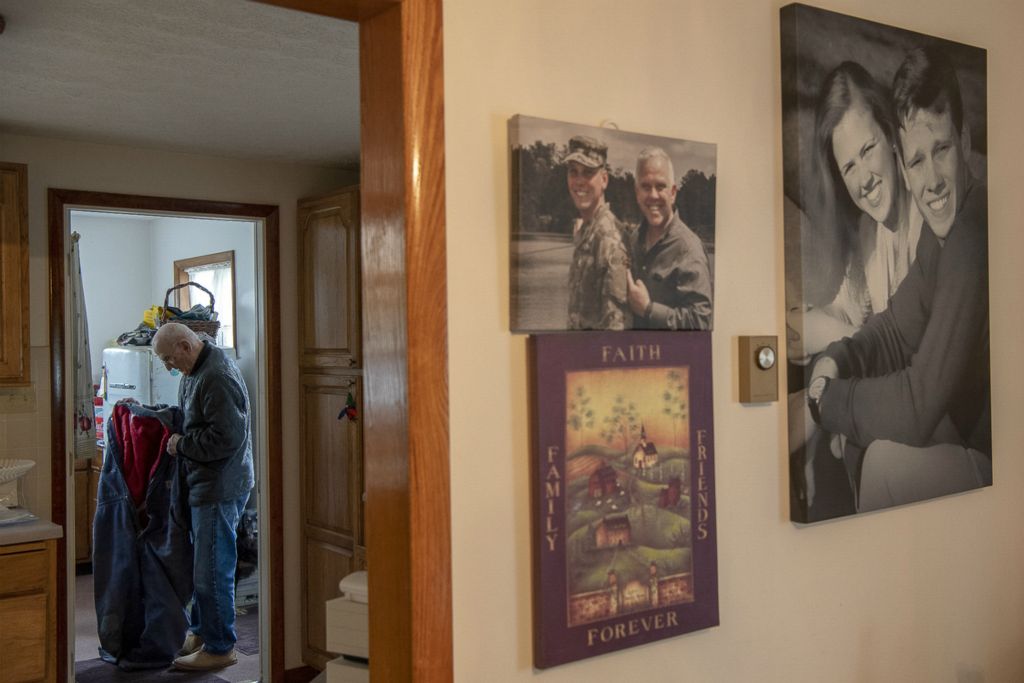 First Place, Chuck Scott Student Photographer of the Year - Gaelen Morse / Ohio UniversityJohn Rice, of Tuppers Plains, Ohio, prepares to dress in his insulated coveralls inside his home on Rice Run Road in Tuppers Plains, Ohio, on February 18, 2019. Rice, now the only person residing on the farm, lives in his childhood home surrounded by pictures of family that adorn his walls.
