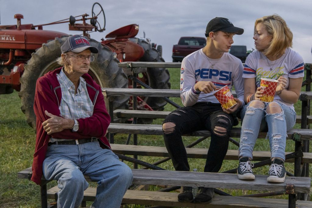 First Place, Chuck Scott Student Photographer of the Year - Gaelen Morse / Ohio UniversityA teenage couple eat french fries together while an elderly gentlemen watches a tractor pull as the sun sets over the Sweet Corn Festival in Millersport, Ohio, on Aug. 31, 2019.