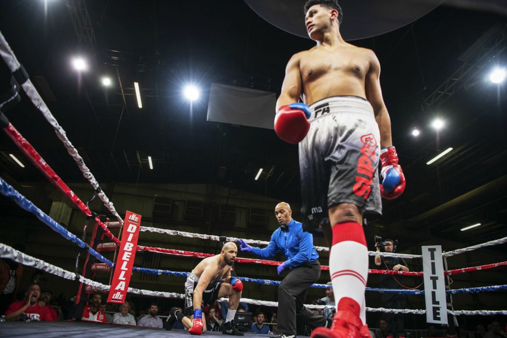First Place, Chuck Scott Student Photographer of the Year - Gaelen Morse / Ohio UniversityHeavyweight boxer Junior Fa walks away from his opponent Newfel Ouatah after knocking him down in the first round during of the Arnold Sports Festival Pro Boxing main event in Columbus, Ohio, on March 2, 2019. Fa would go on to win by TKO in the first round.