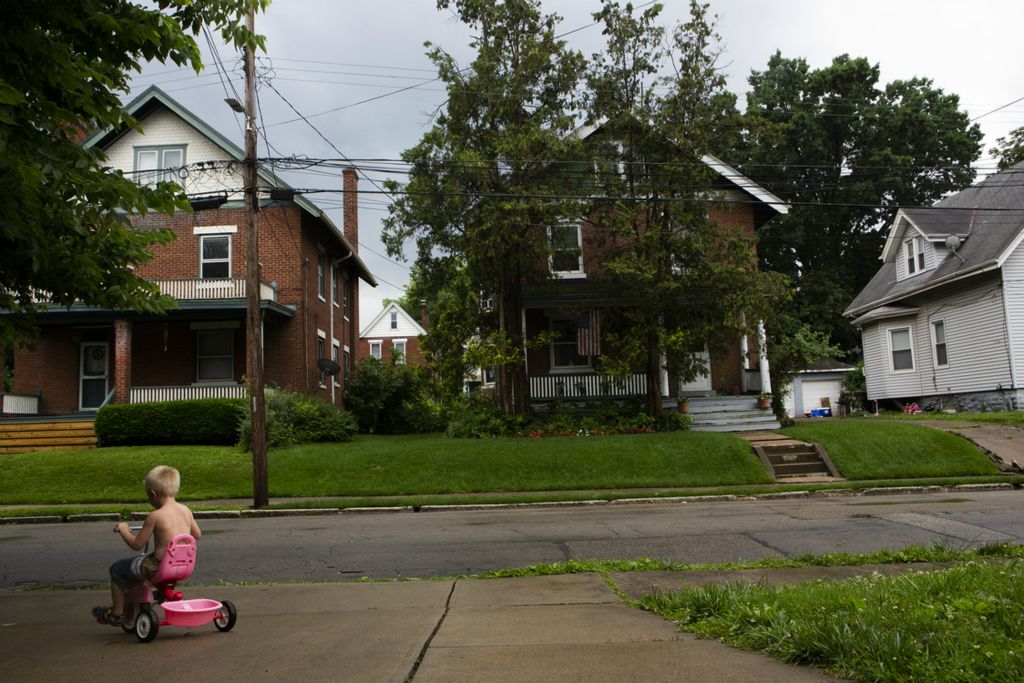 Second Place, Chuck Scott Student Photographer of the Year - Madeleine Hordinski / Ohio UniversityA boy rides his tricycle in Norwood on Wednesday, June 19, 2019. Norwood is a neighborhood hard-hit by overdoses this summer, according to daily overdose reports from Hamilton County Public Health and the Hamilton County Heroin Coalition. Kristie Combs, who babysits the boy, said she has lost family and friends to heroin overdose.