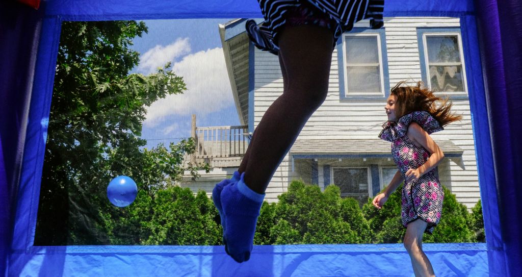 First Place, Feature - Jeremy Wadsworth / The Blade, “Bounce House”At right Makayla Jackson, 6, jumps inside a bounce house  along with  Adaliyah McClain, 6, during a "Party in the Parking Lot" on June 25, 2019, at the Birmingham Branch Library in Toledo.