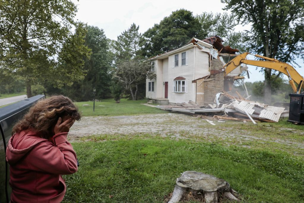 Award of Excellence, Feature - Joshua A. Bickel / The Columbus Dispatch, “The Corrigan House”Tracy Corrigan (left) weeps as an excavator tears down her house along Morse Road on August 23, 2019 in Jersey Township. Corrigan and her husband, Scott, bought their home in the 1980s and raised their five children there. Recently, the property was annexed into nearby New Albany from Jersey Township, and the Corrigan's sold their home to the New Albany Company to make way for development. Nearby, Facebook, Google and Amazon have all built facilities in New Albany International Business Park.