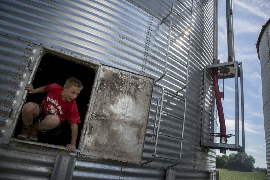First Place, Feature Picture Story - Jessica Phelps / Newark Advocate, “A Farm Story”Bryce Hollenback jumps out a silo on the family farm in July, 2018 looking for his next adventure. Growing up on a family farm in rural Ohio offers a freedom to the Hollenback boys while also instilling in them a sense of self pride and responsibility. They are always ready to help their parents out but love running around through the fields and climbing tress. Bryce's parents bought the farm before he was born and have built it up over the years hoping to leave a legacy for their children. 
