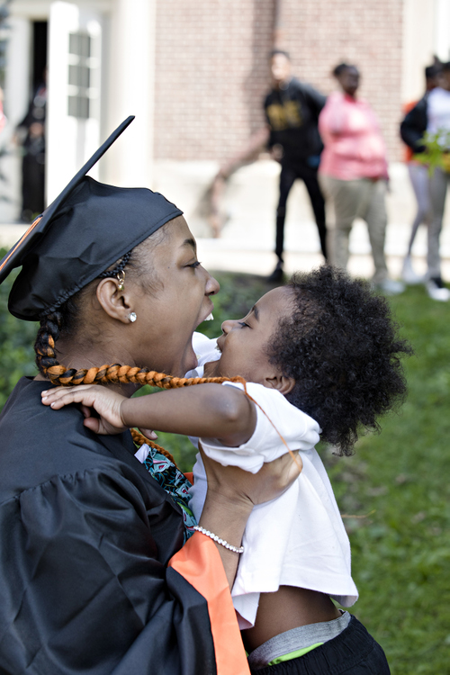 Third Place, Feature Picture Story - Albert Cesare / The Cincinnati Enquirer, “Finding Home”Genéa Bouldin, 18, lifts her brother Solomon, 5, during the Withrow University High School Bridge Walk celebration of graduates on May 16, 2019.