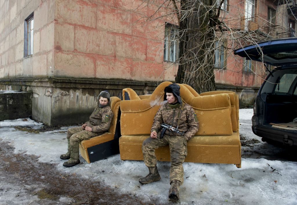 Award of Excellence, Feature Picture Story - Matthew Hatcher / Freelance, “Ukraine's Forgotten War”Soldiers of the 54th Mechanized Rifle Brigade take a break from helping residents move from an apartment building at 'Point Zero' in Zolote-4, Ukraine on March 1, 2019. Shelling and continued fighting in an increasingly stagnant yet deadly war has displaced some 1.5 million Ukrainian civilians.