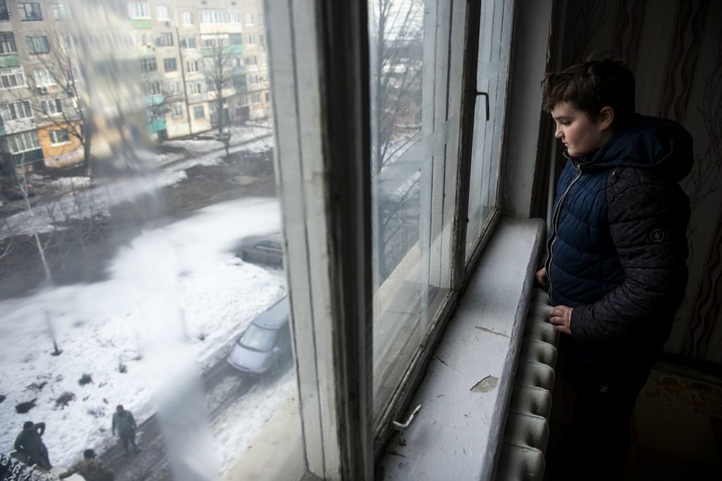 Award of Excellence, Feature Picture Story - Matthew Hatcher / Freelance, “Ukraine's Forgotten War”A young Ukrainian boy watches as soldiers unload he and his mothers possessions from the back of a military truck in Zolote, Ukraine on March 1, 2019. He and his mother previously lived in Zolote-4, however, a night of heavy shelling from Russian backed separatists forced them to move from their apartment to a location farther from the frontlines and now they are among the 1.5 million internally displaced Ukrainians of the war.