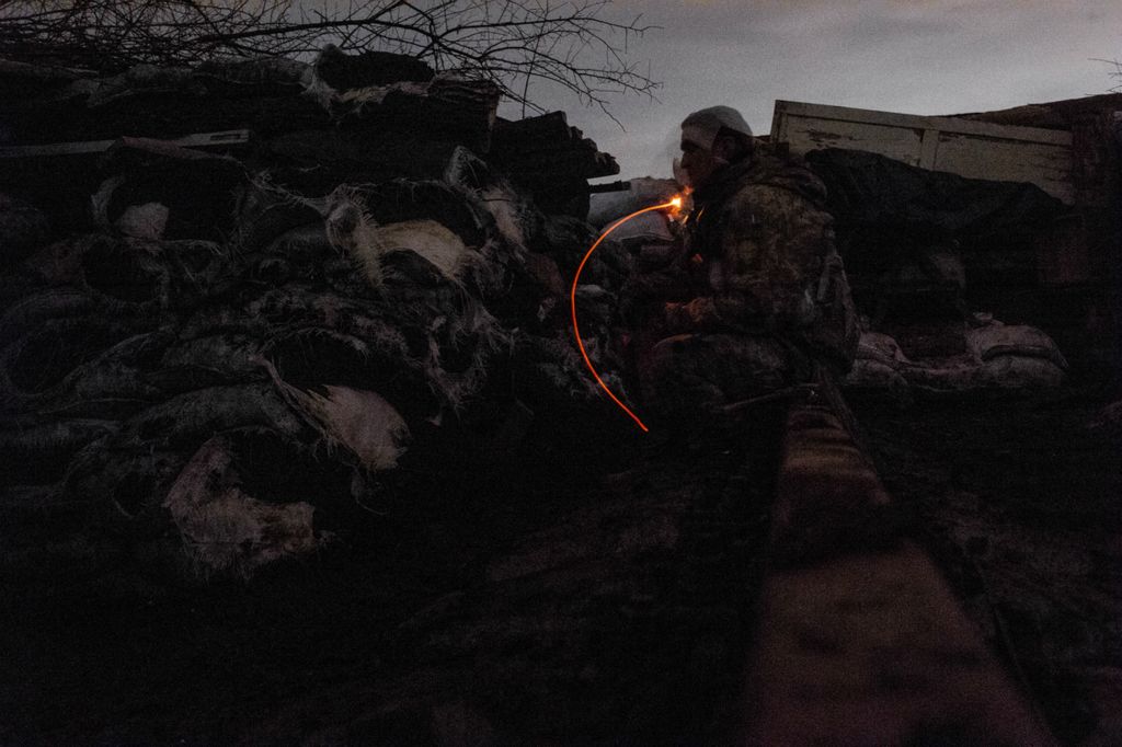 Award of Excellence, Feature Picture Story - Matthew Hatcher / Freelance, “Ukraine's Forgotten War”As night falls sporadic firefights and shelling breakout around Zolote-4, in Ukraine, a soldier smokes a cigarette while on his guard shift at 'Point Zero' on February 27, 2019. A week earlier a soldier had been wounded in a mortar attack, and by March the soldiers occupying the position had already lost several of their number. The outpost, only a few hundred yards from separatist positions and referred to as 'Point Zero' by soldiers and civilians, is subject to frequent shelling and sporadic firefights between Ukrainian soldiers and Russian backed separatists.
