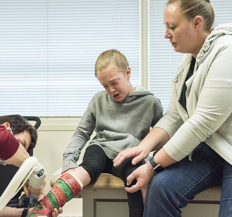 Second Place, Larry Fullerton Photojournalism Scholarship - Alexandria Skowronski / Ohio UniversitySophia is comforted by her mother Melissa (right) as her doctor removes her cast from her November surgery on  December 28, 2018. Sophia wanted more physical support on her feet, because that is what she is used to, saying, "I am scared - I don't want to walk barefoot."