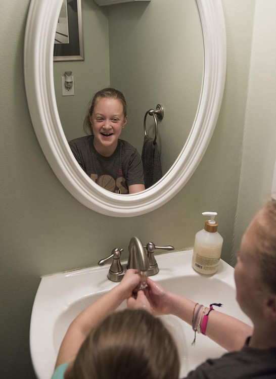 Second Place, Larry Fullerton Photojournalism Scholarship - Alexandria Skowronski / Ohio UniversitySophia laughs while helping her little sister Maddie wash her hands after making a craft during their garage sale on May 18, 2019. 