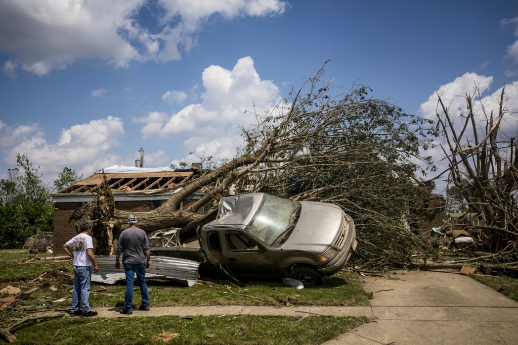 Third Place, News Picture Story - Meg Vogel / The Cincinnati Enquirer, “Brookville Tornado”Scot Shellabarger stands outside his home with a neighbor and surveys the damage caused by a tornado that touched down in Brookville, Ohio on Tuesday, May 28, 2019.