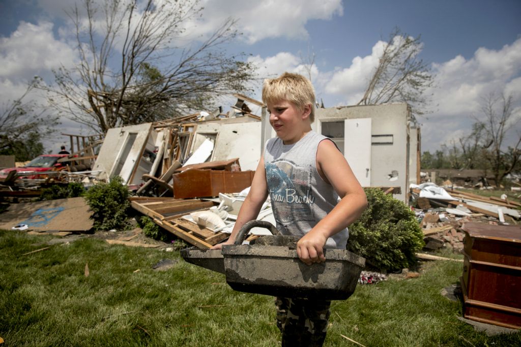 Third Place, News Picture Story - Meg Vogel / The Cincinnati Enquirer, “Brookville Tornado”Alex Dawson gathers debris from his neighbor's home that was destroyed by a tornado in Brookville, Ohio on Tuesday, May 28, 2019.