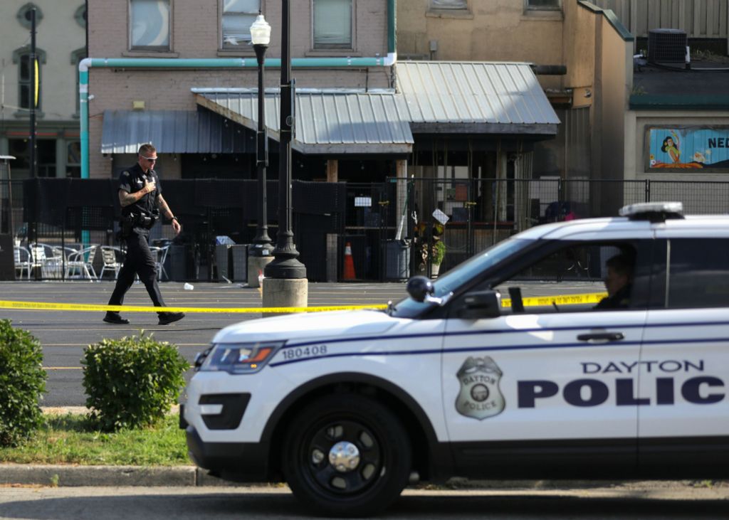 First Place, News Picture Story - Kurt Steiss / The Blade, “Dayton Shooting”A police officer walks by in a parking lot behind Ned Peppers in the Oregon District in Dayton, Ohio, on Sunday, Aug. 4, 2019.