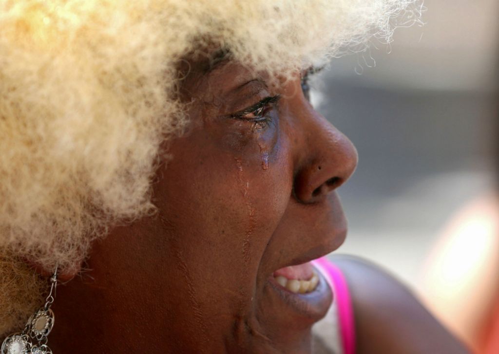 First Place, News Picture Story - Kurt Steiss / The Blade, “Dayton Shooting”Annette Gibson-Strong, from Dayton, sheds tears as she speaks to the media outside Ned Peppers at the Oregon District in Dayton, Ohio, on Monday, Aug. 5, 2019. She had taken it upon herself to take care of the makeshift memorial.