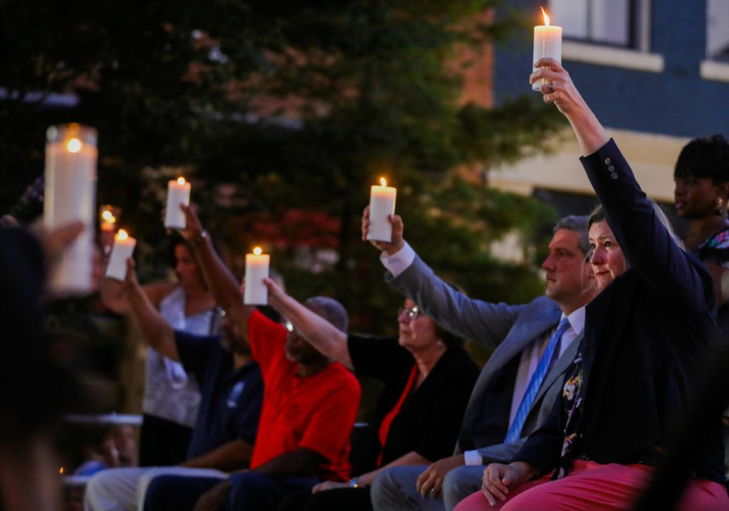 First Place, News Picture Story - Kurt Steiss / The Blade, “Dayton Shooting”Dignitaries including Dayton Mayor Nan Whaley, right, raise their candles during an evening vigil held in the Oregon District in Dayton, Ohio, on Sunday, Aug. 4, 2019. 
