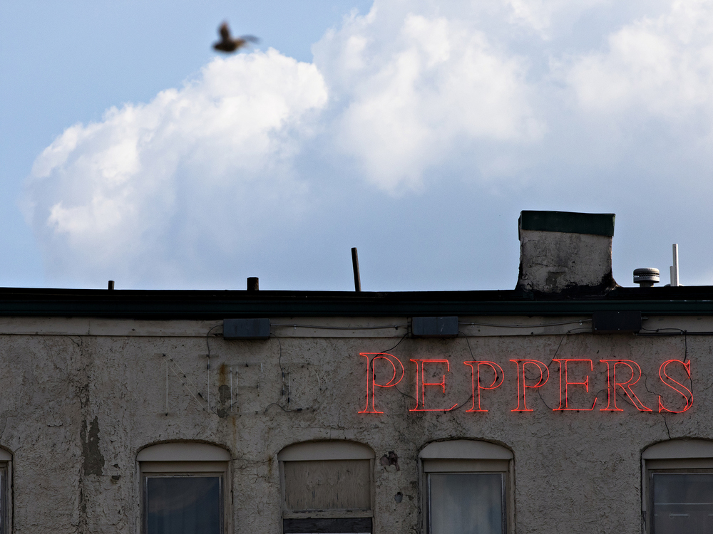 Award of Excellence, News Picture Story - Albert Cesare / The Cincinnati Enquirer, “Mass Shooting Dayton ”A view of the rear of Ned Peppers sign behind the 400 block of E. Fifth Street, where a mass shooting that left ten dead, including the shooter, and 26 injured Sunday, Aug. 4, 2019, in Dayton, Ohio. 