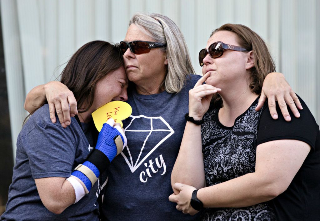 Award of Excellence, News Picture Story - Albert Cesare / The Cincinnati Enquirer, “Mass Shooting Dayton ”Joan Fultz, center, embraces her daughter's Emily Murphy, left, and Audrey Carreira, right, during a vigil for the victims of a mass shooting in the Oregon District of Dayton, Ohio, on Sunday, Aug. 4, 2019. 