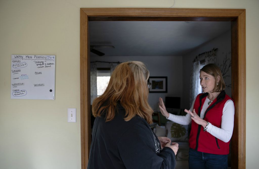 First Place, James R. Gordon Ohio Understanding Award - Erin Burk / Ohio University, “Serenity Grove”Executive Director Betsy Anderson (right) tells Shauna Hyde about how Serenity Grove functions as Hyde is starting a recovery house with her own group home in Parkersburg, W.Va. 