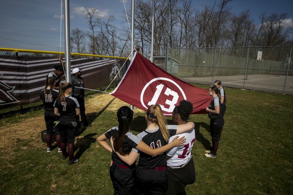 First Place, Photographer of the Year - Large Market - Meg Vogel / The Cincinnati EnquirerThe Western Hills varsity softball team raises a flag with Gabrielle “Gabby” Rodriguez's number on it Wednesday, April 3, 2019 at Western Hills University High School at the field dedication for Gabby, a Western Hills softball player who was killed by a motorist in September while crossing the street to catch her bus to school. 