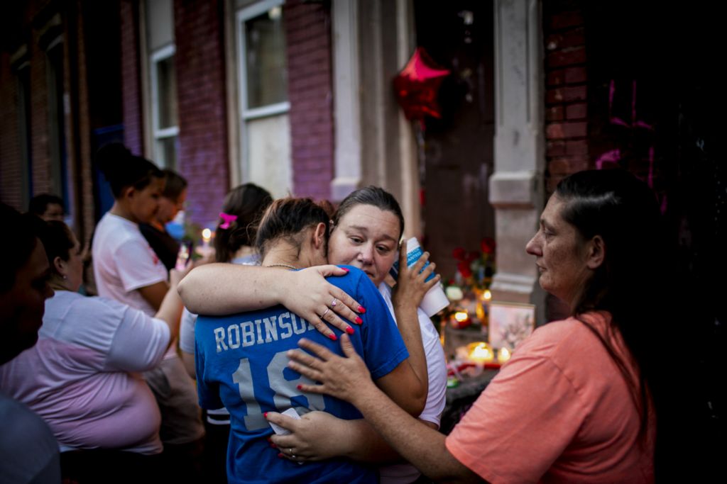 First Place, Photographer of the Year - Large Market - Meg Vogel / The Cincinnati EnquirerDenitria Robinson hugs Patty Franklin, the mother of Cameron Franklin, who was shot and killed Saturday, during a candlelight vigil on Storrs Street in Lower Price Hill Monday, July 8, 2019. Denitria went to school with Cameron and played baseball with him.