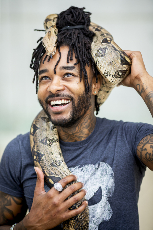 First Place, Photographer of the Year - Large Market - Meg Vogel / The Cincinnati EnquirerAri White holds his snake Bam Bam, a red-tailed boa constrictor in downtown Cincinnati on Wednesday, July 3, 2019. White has owned Bam Bam for three years.