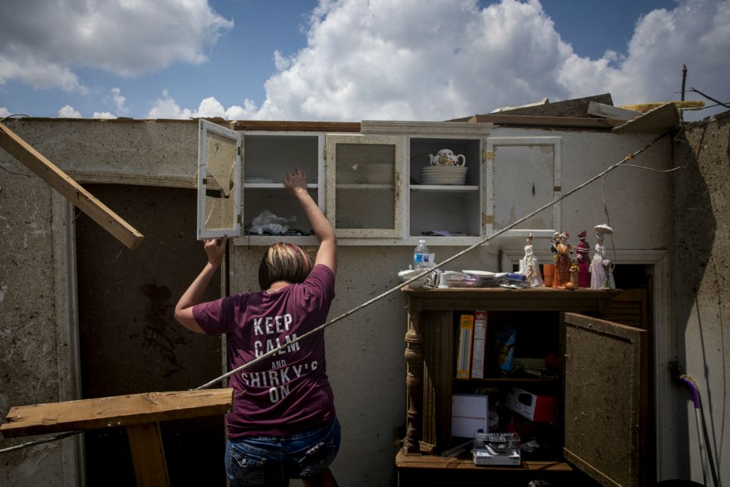 First Place, Photographer of the Year - Large Market - Meg Vogel / The Cincinnati EnquirerSusan Smith removes the dishes out of her sister-in-law's home that was destroyed by tornadoes in Brookville, Ohio on Tuesday, May 28, 2019.