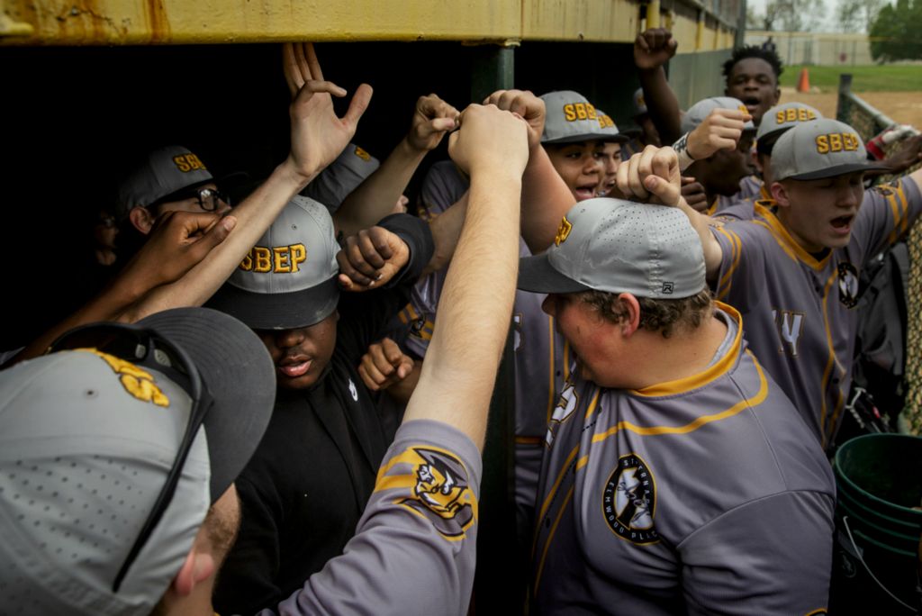 First Place, Photographer of the Year - Large Market - Meg Vogel / The Cincinnati EnquirerSt. Bernard Titans huddles before their game against Lockland at Ross Park in St. Bernard on Tuesday, April 23, 2019.  St. Bernard Titans have lost 55 straight games over the past three seasons. In his first season as head coach, Fred James has tried to change that record. He started with getting his players new uniforms and equipment. James organized a fundraiser, found sponsors and gathered donated helmets and bats.