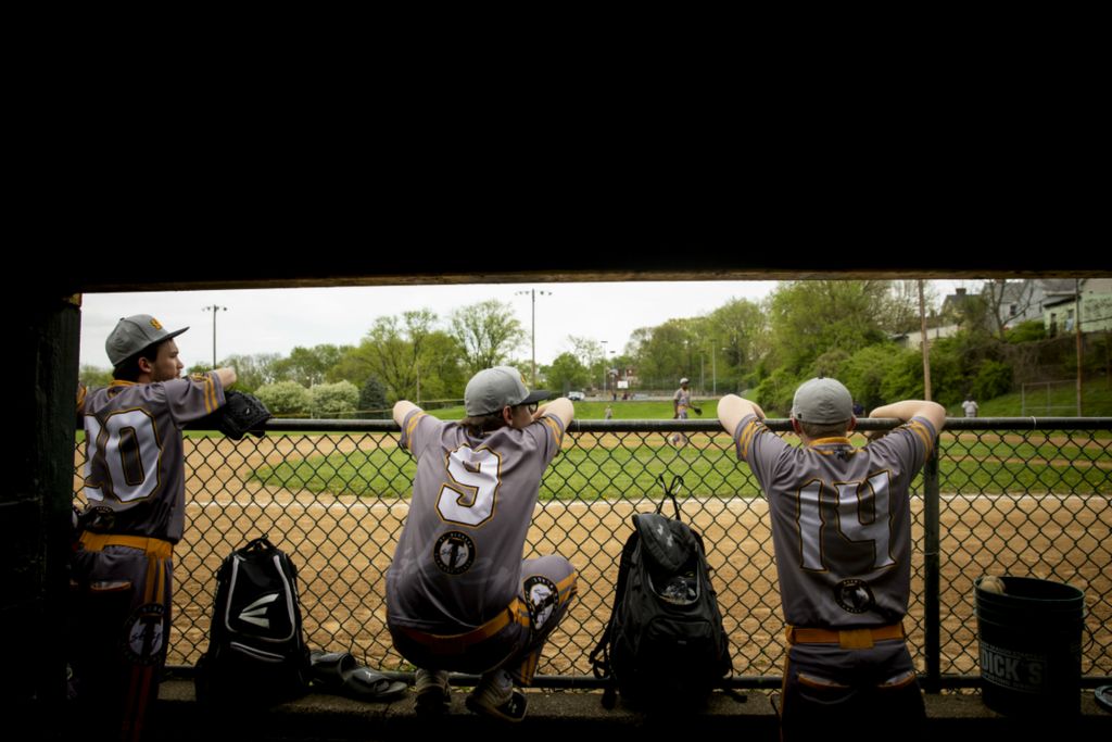 First Place, Photographer of the Year - Large Market - Meg Vogel / The Cincinnati EnquirerLogan Harper, Scott Bine and Dylan Shepherd watch their team, St. Bernard Titans, from the dugout at Ross Park in St. Bernard on Tuesday, April 23, 2019.