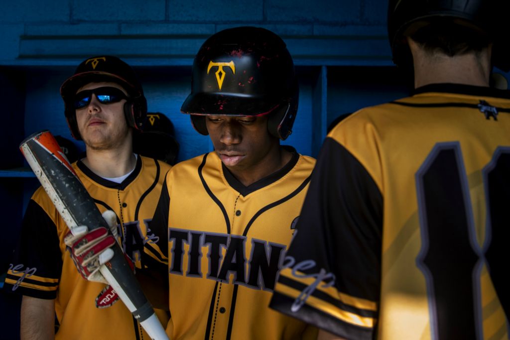 First Place, Photographer of the Year - Large Market - Meg Vogel / The Cincinnati EnquirerKevin Oliver grabs his bat to hit against Summit Country Day School at Summit's Athletic Complex in Columbia Township on Friday, April 26, 2019. 