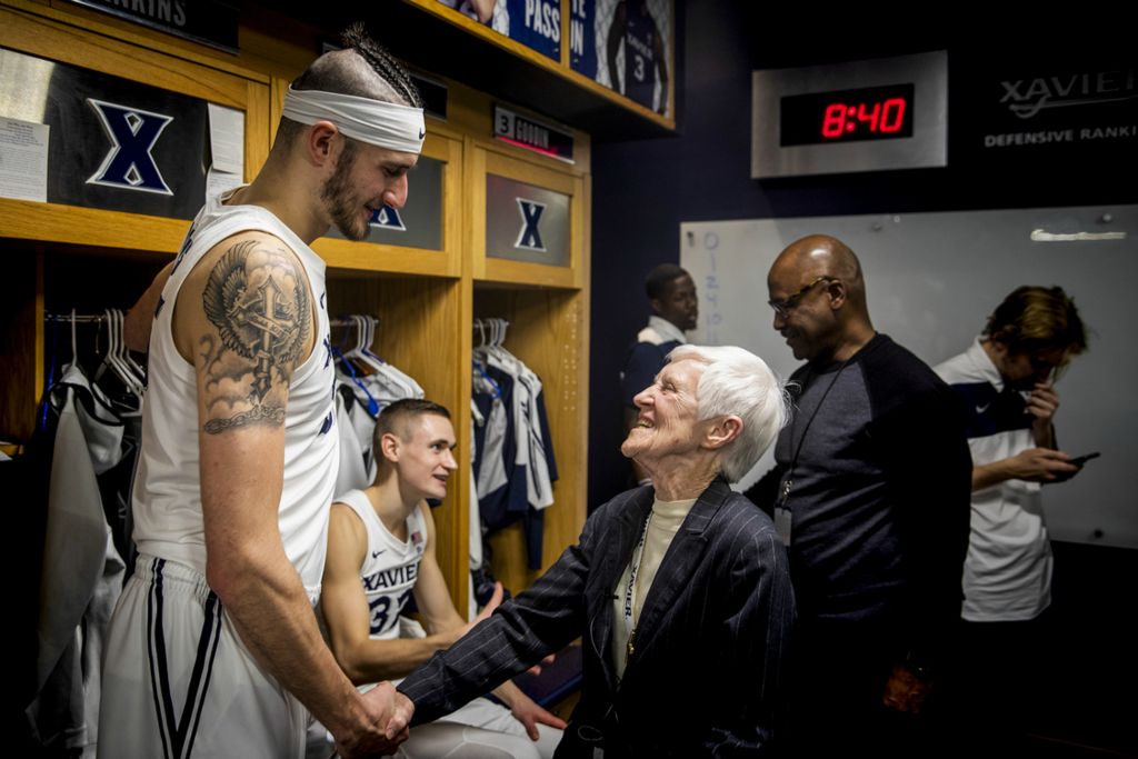 First Place, Photographer of the Year - Large Market - Meg Vogel / The Cincinnati EnquirerSr. Rose Ann Fleming congratulates Xavier forward Zach Hankins after his team's victory over Georgetown Wednesday, January 9, 2019 in the locker room at the Cintas Center. Fleming has worked at Xavier University for 34 years as a teacher, academic advisor, special assistant to the president and NCAA faculty athletics representative. Fleming attends every home game and sometimes travels with the team.