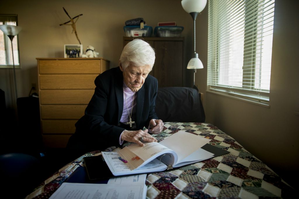 First Place, Photographer of the Year - Large Market - Meg Vogel / The Cincinnati EnquirerSr. Rose Ann Fleming sits on her bed and prepares a brief for a social security hearing that she is working on as part of The Volunteer Lawyers Project Saturday, February 16, 2019 in her apartment on Xavier University's campus. Fleming talks about not giving up on people and says, "We all make mistakes." Fleming draws inspiration from Robert K. Greenleaf, author of the book "Servant Leadership," to define success. "Did I help anyone today? If you did, you were successful. I have always been inspired by that definition," she says. She worked on the case while watching Xavier play Providence Friars men's basketball team. She has lived in the same apartment for 34 years. It is a bit larger than a dorm room and has an elliptical for her to do her daily exercises.