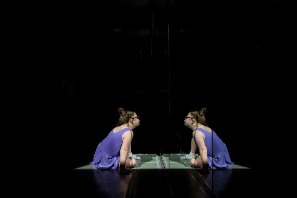 First Place, Photographer of the Year - Large Market - Meg Vogel / The Cincinnati EnquirerAva Katz, 9, sits in a patch of sun and watches her reflection move in the mirror during her Ballet Moves class on Saturday, February 16, 2019 at the Cincinnati Ballet in the West End. Ava has Down syndrome. She has been part of the class for five years. Ballet has helped strengthen her core, which helps language skills. And it has given Ava more confidence. When asked how many more years she wants to dance, she was quick to respond. "One hundred dozen more."