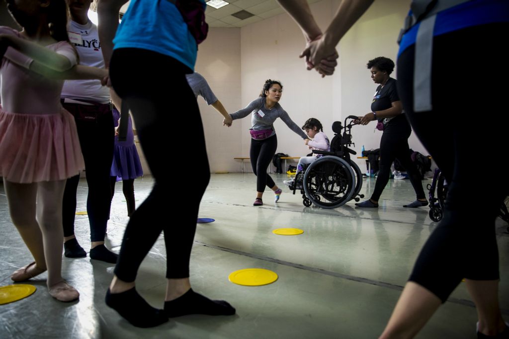 First Place, Photographer of the Year - Large Market - Meg Vogel / The Cincinnati EnquirerEllen Wisner holds Evelyn Ortiz's hand as Erin Butler pushes her wheelchair to dance in a circle at the Ballet Moves class at the Cincinnati Ballet on Saturday, February 2, 2019.  