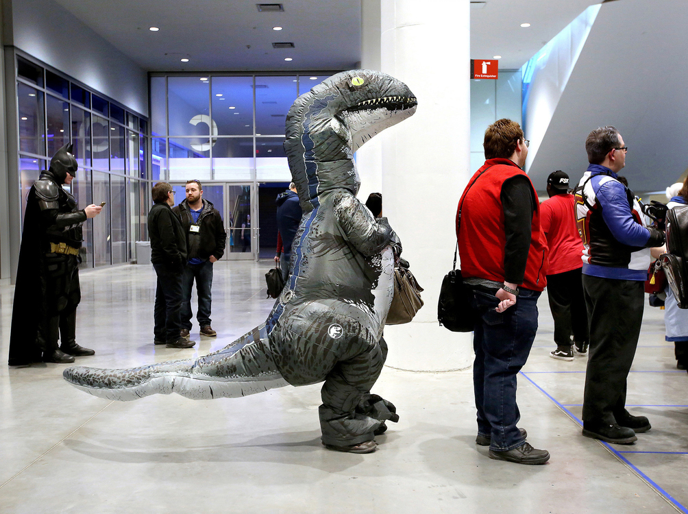 Second Place, Photographer of the Year - Large Market - Lisa DeJong / The Plain DealerJustin Yoder, 31, of Cuyahoga Falls, politely stands in line wearing a velociraptor costume as he waits to go into Wizard World at the Huntington Convention Center. Yoder said he is "Blue", a velociraptor from the movie "Jurassic World". Wizard World welcomes people to dress as their favorite movie or comic character.