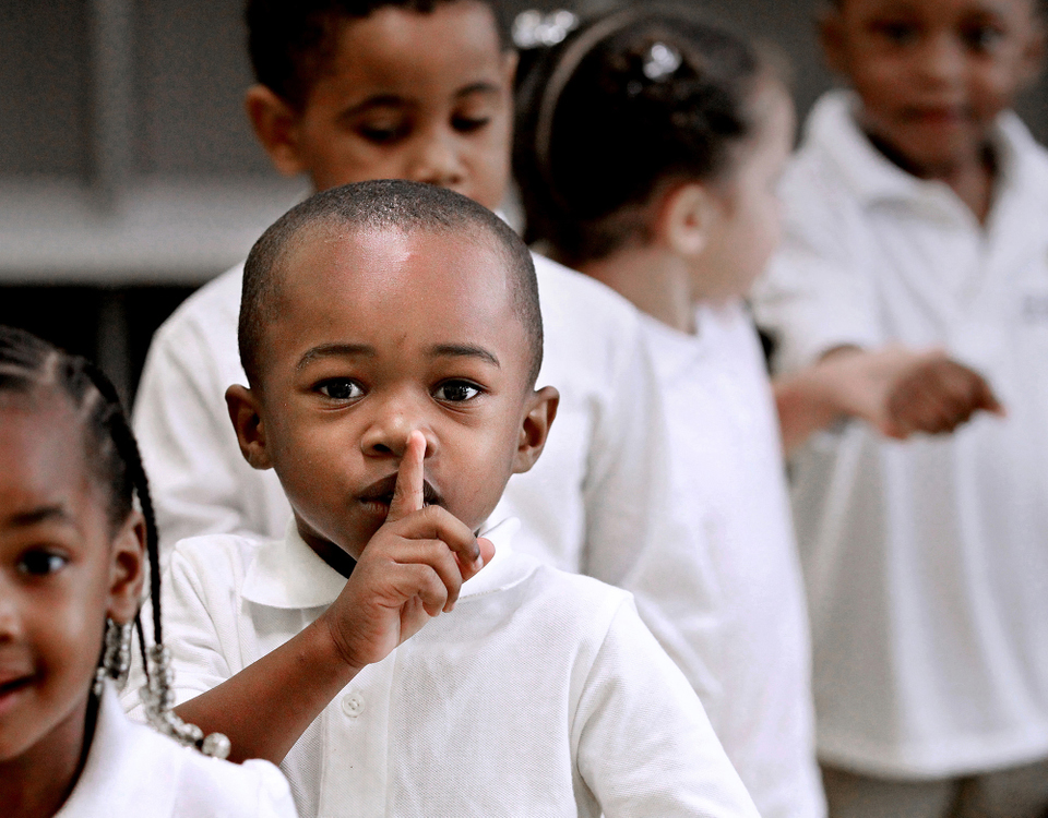 Second Place, Photographer of the Year - Large Market - Lisa DeJong / The Plain DealerJaden Cooper, 3, puts his finger to his lips for students to be quiet as he lines up with his pre-kindergarten classmates. A ribbon-cutting ceremony was held for the newly opened Cletus Jeckering Learning Center at Saint Adalbert Catholic School in the Fairfax neighborhood. 