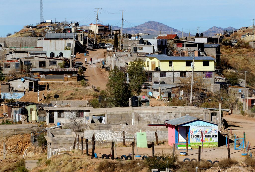 Second Place, Photographer of the Year - Large Market - Lisa DeJong / The Plain DealerChildren are fed by volunteers here at Escuela Biblica N.A.N.A. in the Rosarito Dos neighborhood high above Nogales, Sonora, Mexico. The N.A.N.A. Ministry, a Hispanic title which translates to Children Helping Grateful Children, is a non-profit organization that feeds and houses children in the poor neighborhood of Rosarito Dos. The need is great, as many of the children's parents have left to cross the border into the United States. 