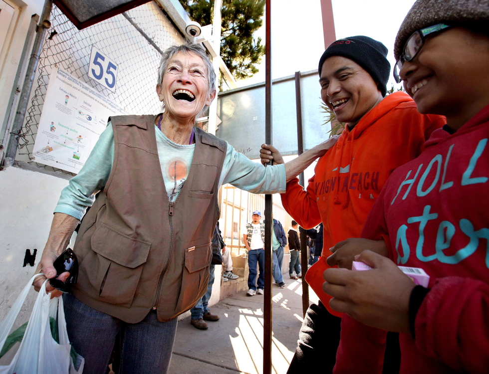 Second Place, Photographer of the Year - Large Market - Lisa DeJong / The Plain DealerVolunteers are proving that compassion rules at the border. Samaritan co-founder, Shura Wallin, 77, left, adds some levity to the dire situation as she laughs with Edwin Velásquez, 34, and his daughter Cintia Velásquez, 12, as they wait outside the food shelter she helps run called El Comedor near the border in Nogales, Sonora, Mexico. The father and daughter have practically walked to Nogales to escape the violence in their home country of Guatemala. Wallin, who used to run a homeless shelter in Berkeley, California, has been volunteering down in Nogales for almost 20 years. Wallin has a black belt in karate and offered to teach self defense to women coming through the shelter. El Comedor, run by Jesuit priests and nuns, turned down her offer. 