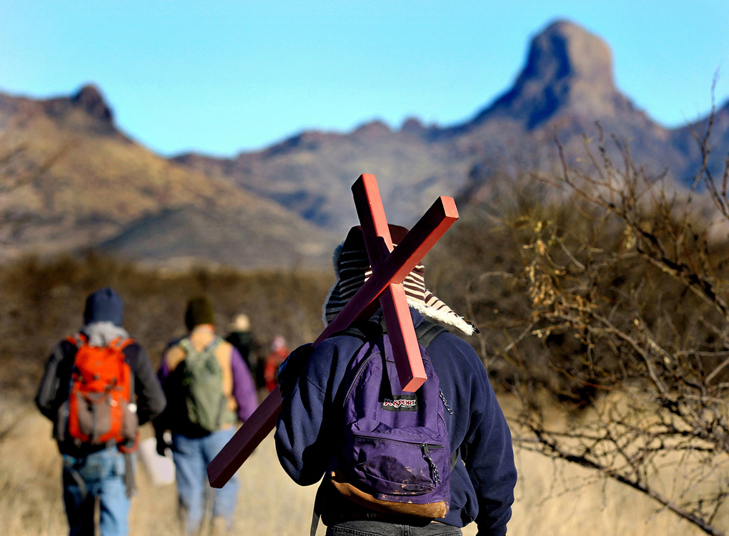 Second Place, Photographer of the Year - Large Market - Lisa DeJong / The Plain Dealer"The government is using the desert to kill people," says artist Alvaro Enciso about the desperate migrants making their way north in the harsh desert from the Mexican border. "They died looking for the American dream." James Goodreau, 76, of Tucson, carries a wooden cross while following Enciso through the Altar Valley, just east of the Baboquivari Mountains, 50 miles southwest of Tucson in Pima County. The cross Goodreau is carrying is for Olaf Avila Gonzalez, a 19-year-old Mexican male migrant, whose skeletal remains were found in the desert in 2004. "The vultures do very well out here," Ensico says. "They always have dead bodies to eat.” Goodreau is volunteering with artist Alvaro Enciso for his public art project called "Donde Mueren Los Suenos", or "Where Dreams Die". Enciso says he has covered 40,000 square miles, putting up crosses to honor migrants whose remains have been found in the desert. He has planted over 850 crosses in the desert over the last six years. The peak on the Baboquivari Mountains, in background, has been used as a navigation point by migrants crossing the border heading north. It is a sacred mountain for the Tohono O'odham Nation. Enciso has a team of volunteers for every weekly outing. His project is based on the information and GPS coordinates that the medical examiner in Pima County keeps for migrant deaths in southern Arizona.