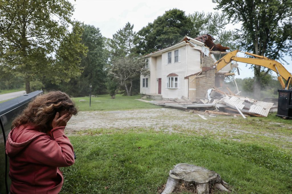 Third Place, Photographer of the Year - Large Market - Joshua A. Bickel / The Columbus DispatchTracy Corrigan, left, weeps as an excavator tears down her house along Morse Road on Friday, August 23, 2019 in Jersey Township, Ohio. Corrigan and her husband, Scott, bought their home in the 1980s and raised their five children there. Recently, the property was annexed into nearby New Albany from Jersey Township, and the Corrigan's sold their home to the New Albany Company to make way for development. Nearby, Facebook, Google and Amazon have all built facilites in New Albany International Business Park.