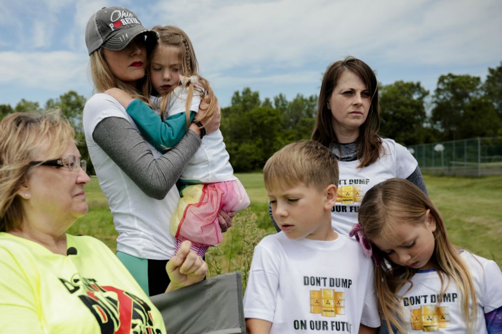 Third Place, Photographer of the Year - Large Market - Joshua A. Bickel / The Columbus DispatchCrystal Glass, center, of Piketon, Ohio, holds her daughter, Ruby Torian, 5, while protesting with about 15 other people outside a U.S. Department of Energy Environmental Cleanup Update on the former Portsmouth Gaseous Diffusion Plant on Tuesday, May 21, 2019 at the Pike County YMCA in Waverly, Ohio. Earlier in the year, traces of radioactive material were detected inside Zahn’s Corner Middle School about a mile from the plant and where Glass was a student from 1993 through 1995. In April 2018, she was diagnosed with Bartholin's adenocarcinoma, a extremely rare form of vulvar cancer typically seen in postmenopausal women, which she suspects is because of the school’s proximity to the plant.