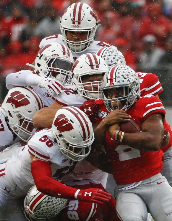 Third Place, Photographer of the Year - Large Market - Joshua A. Bickel / The Columbus DispatchOhio State Buckeyes running back J.K. Dobbins (2) fights Wisconsin Badgers defenders while carrying the ball during the first quarter of a NCAA Division I college football game between the Ohio State Buckeyes and the Wisconsin Badgers on Saturday, October 26, 2019 at Ohio Stadium in Columbus, Ohio.