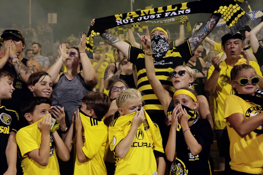 Third Place, Photographer of the Year - Large Market - Joshua A. Bickel / The Columbus DispatchYoung fans cover their faces as smoke bombs are released following the Columbus Crew SC’s 2-1 victory against the Montreal Impact during a MLS game on Saturday, July 20, 2019 at Mapfre Stadium in Columbus, Ohio.