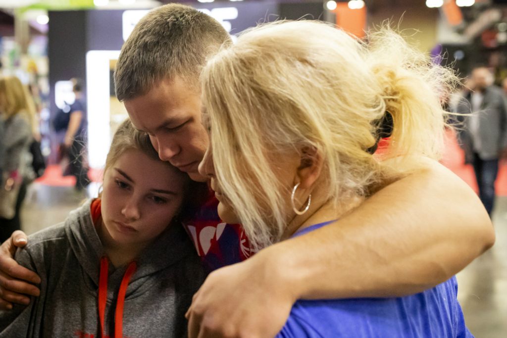 Third Place, Photographer of the Year - Large Market - Joshua A. Bickel / The Columbus DispatchAfter getting into a brief argument with his stepsister, Grace, left, Garrett Ford embraces her and his mother, Leah, right, to apologize while at the Arnold Sports Festival on Sunday, March 3, 2019 at the Greater Columbus Convention Center in Columbus, Ohio. "Family is hugely important to Garrett," Leah Yost said. "He's definitely a peacemaker."