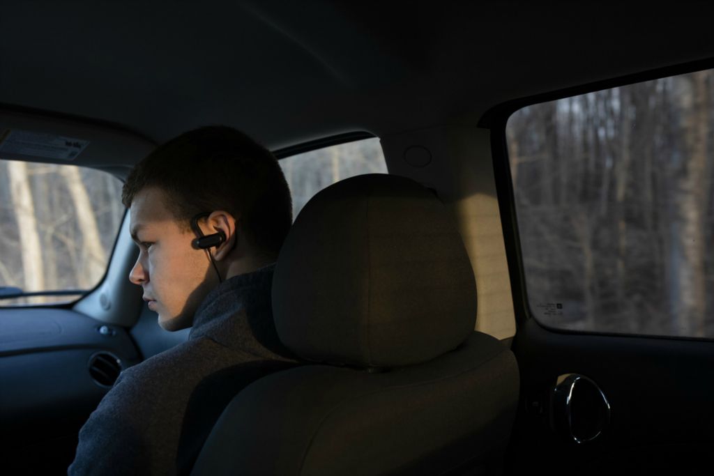 Third Place, Photographer of the Year - Large Market - Joshua A. Bickel / The Columbus DispatchGarrett Ford listens to music as his grandfather, Bill Lane, drives him to Old School Gym for an early-morning lifting session on Wednesday, February 27, 2019 in Pataskala, Ohio. Driving and other independent activities for young adults are difficult for Garrett as a result of his autism, and he has to rely on family members and other social service agencies to get around.