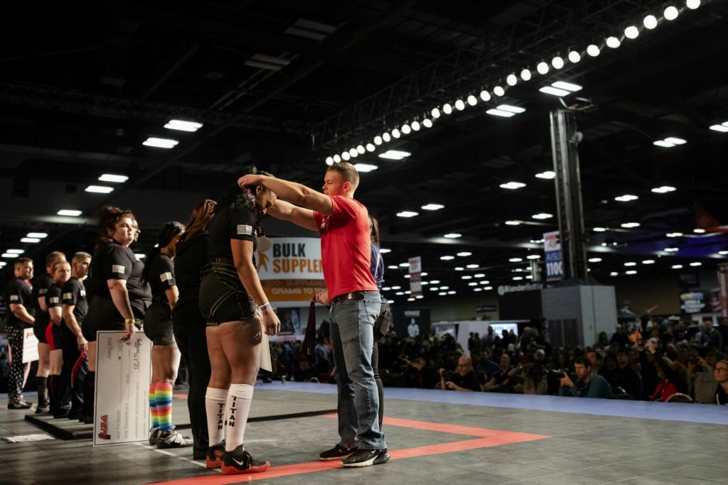 Third Place, Photographer of the Year - Large Market - Joshua A. Bickel / The Columbus DispatchGarrett Ford gives participation medals to competitors following the deadlift competition at the Arnold Sports Festival on Sunday, March 3, 2019 at the Greater Columbus Convention Center in Columbus, Ohio. Before leaving for the Special Olympics World Games, Garrett was invited to present awards at the event and to be recognized as a member of Team USA.