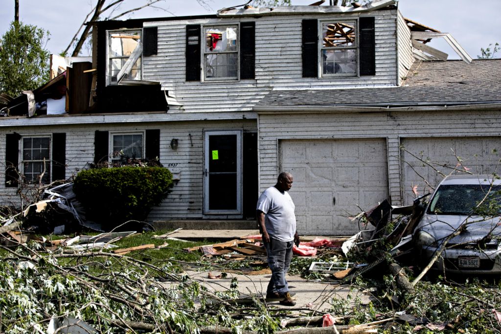 Award of Excellence, Photographer of the Year - Large Market - Albert Cesare / The Cincinnati EnquirerJeff Gurley looks at debris outside his home in the Westrbrooke neighborhood in Dayton, Ohio, on Tuesday, May 28, 2019. A tornado damaged several homes in the neighborhood on Monday night. 