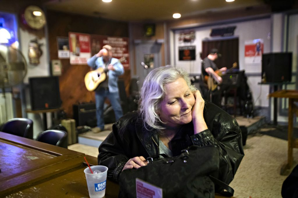 Award of Excellence, Photographer of the Year - Large Market - Albert Cesare / The Cincinnati EnquirerKathy Stevens listens to music while attending a benefit for her at Hillbilly Heaven on Sunday, Feb. 17, 2019, in Middletown. The benefit was held for Kathy Stevens for her medical expenses due to liver disease. Kathy has suffered from breast cancer and ovarian cancer, having a lumpectomy and a radical hysterectomy, as well as going through chemotherapy which damaged her liver. 