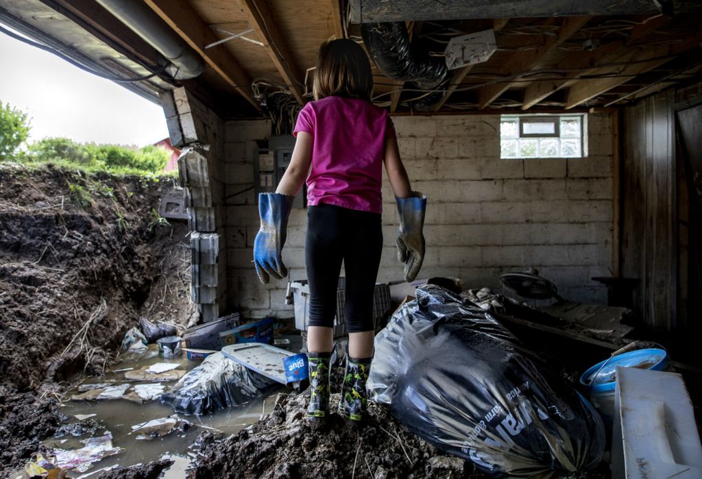 First place, Photographer of the Year - Small Market - Jessica Phelps / Newark AdvocateVayda Dickerson, 6, surveys the damage done in her basement after heavy rains caused the basement wall to collapse on June 24, 2019. Her father, Vic Jr. had been up all night keeping watch as part of the wall started to leak. Around 3am Vayda's mom, Kayci, yelled down to her husband that it seemed as though the house was going to cave in. At that moment the basement wall gave way, knocking Vic Jr. down as water filled the basement. Kayci fled with their three children, while Vic Jr. stayed behind to rescue their dogs. He made it 30 feet down their street before his car broke down due to water damage, and he had to be rescued by first responders. Everyone in the family made it out safely including the dogs.