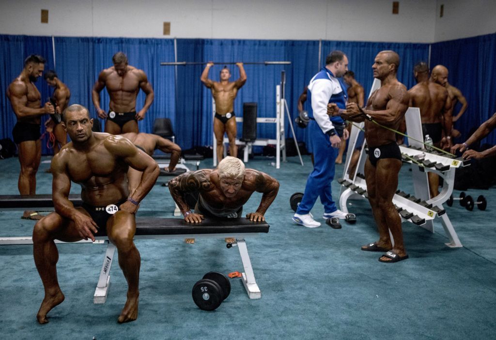 First place, Photographer of the Year - Small Market - Jessica Phelps / Newark AdvocateMen pump their muscles up backstage before competing in  The Arnold Fitness Classic Men’s Physique and Men’s Bodybuilding prejudging show March 1, 2019. 